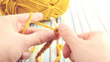 Cropped de crochê amarelo mostarda com correntinhas duplas e caimento leve